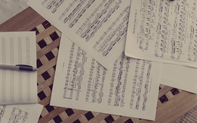 Composing Music For Beginners: Printed sheet music and an empty staff with a pencil, ready for a composer to start working