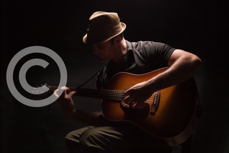 Neighboring Rights Royalties: A songwriter playing his acoustic guitar