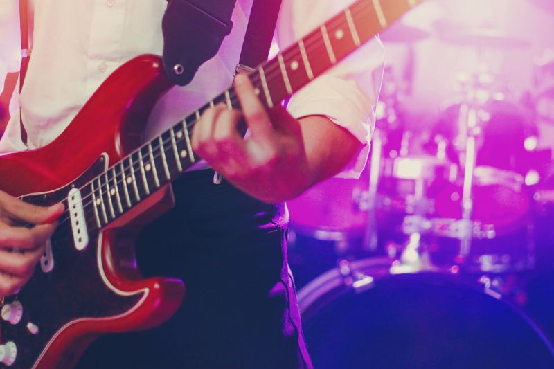 Rock Song Formulas: A person playing a guitar