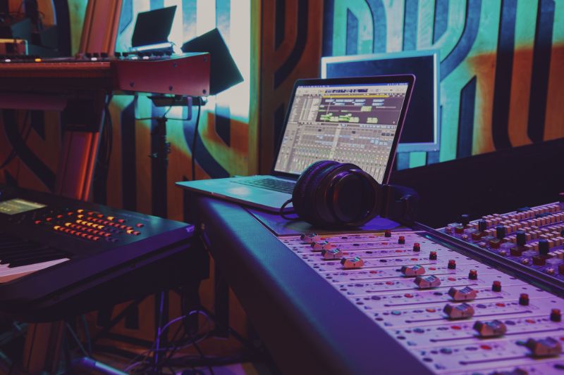 a laptop and headphones on a sound board