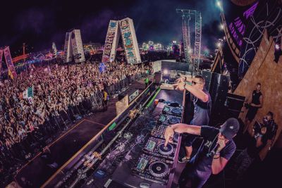 Rhythm and Tempo: DJs on a stage with a large crowd