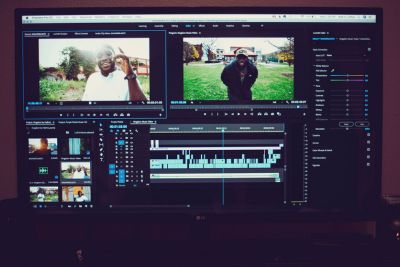 Film maker editing together a music video.