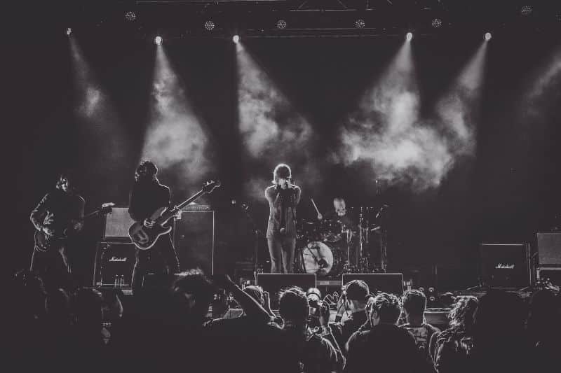 What is a publisher in music: A band performing on stage in front of an audience.