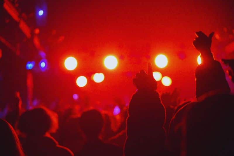 What is drill music? A crowd standing in front of a stage with bright lights, listening to a concert