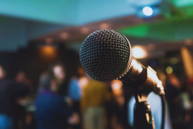 View from behind the microphone on a stage at a music conference netowkring event, where music industry people get to meet.
